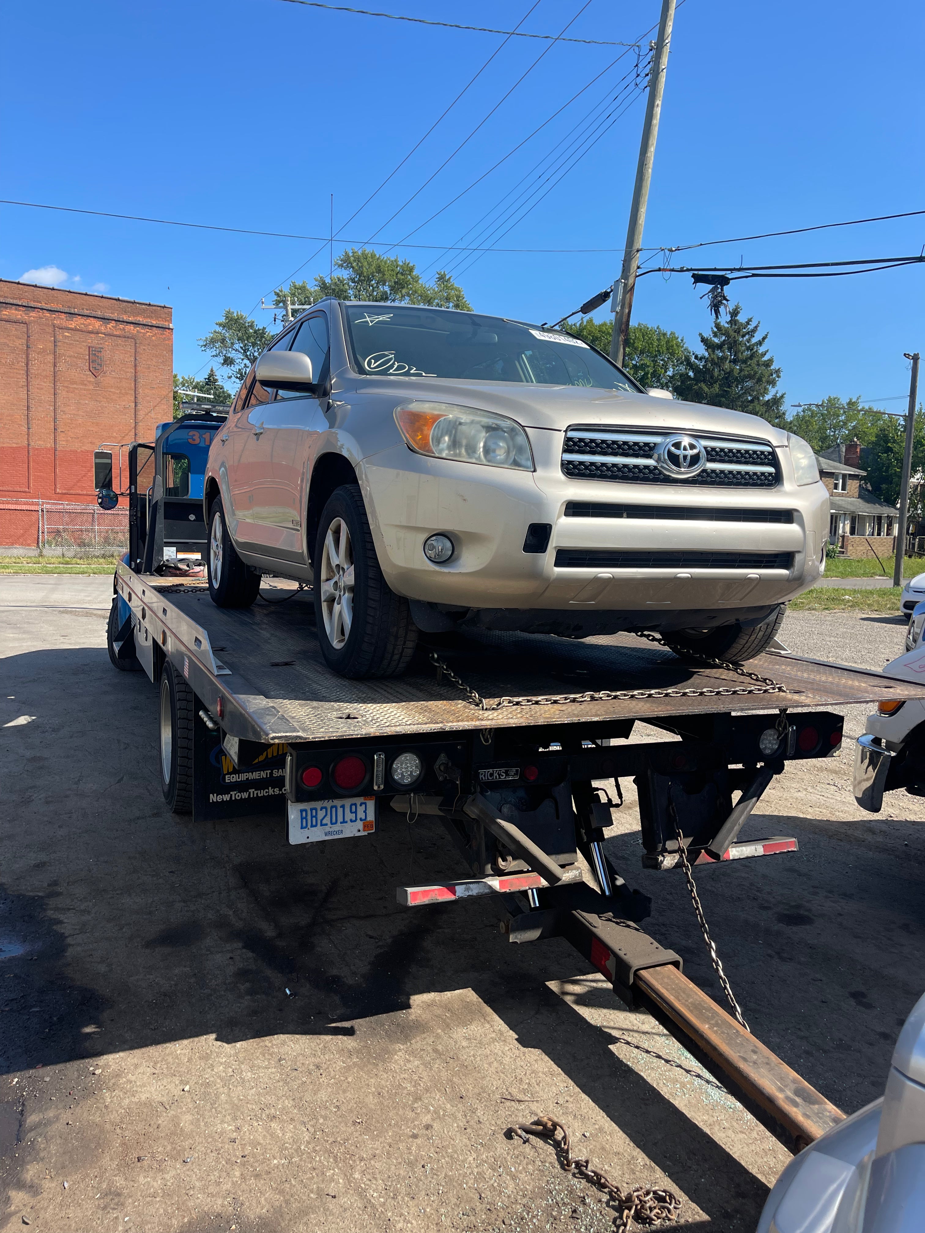 Silver car on towing truck