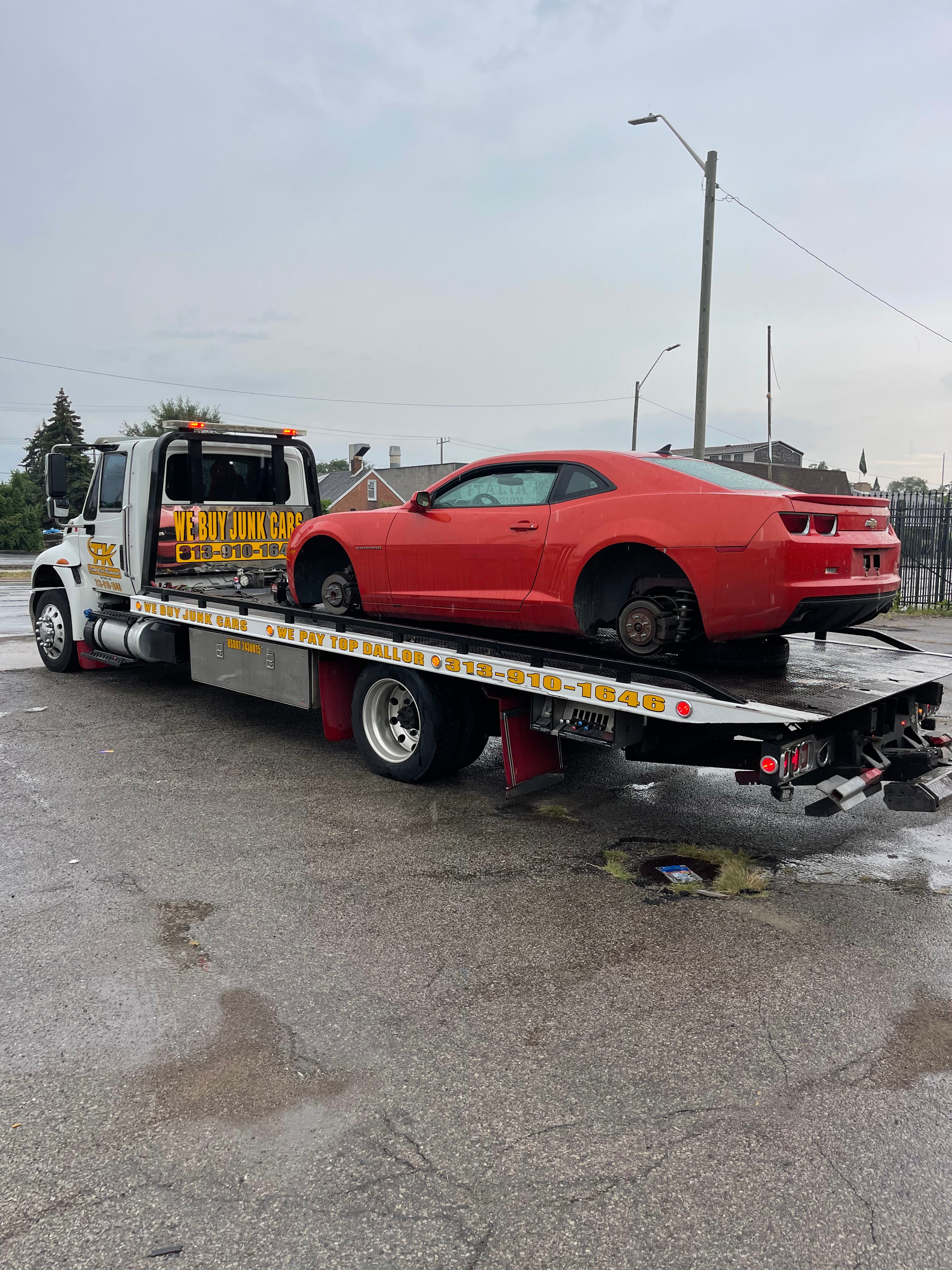 Red car on towing truck