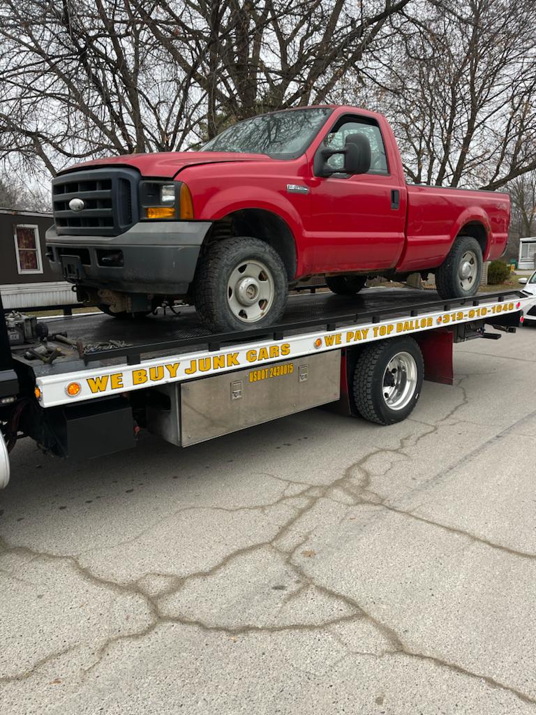 Junk Car Removal Of A Red Ford 